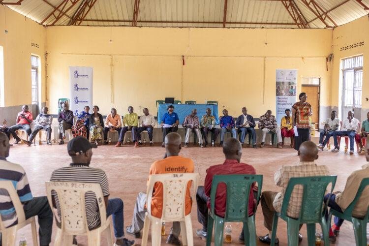 Community members take part in a societal healing and dialogue session