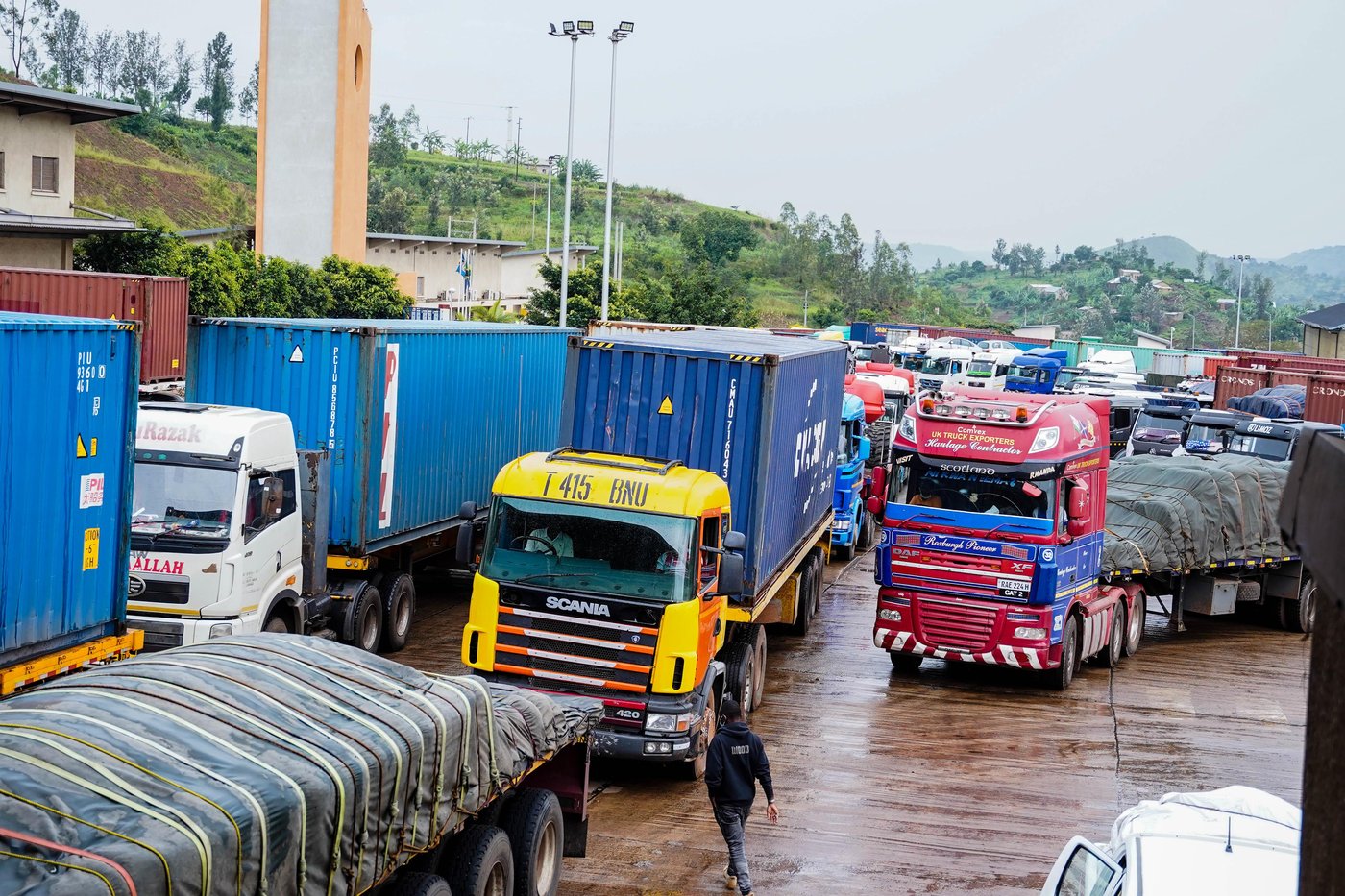 Freight trucks queue at a regional cross-border logistics and trade yard